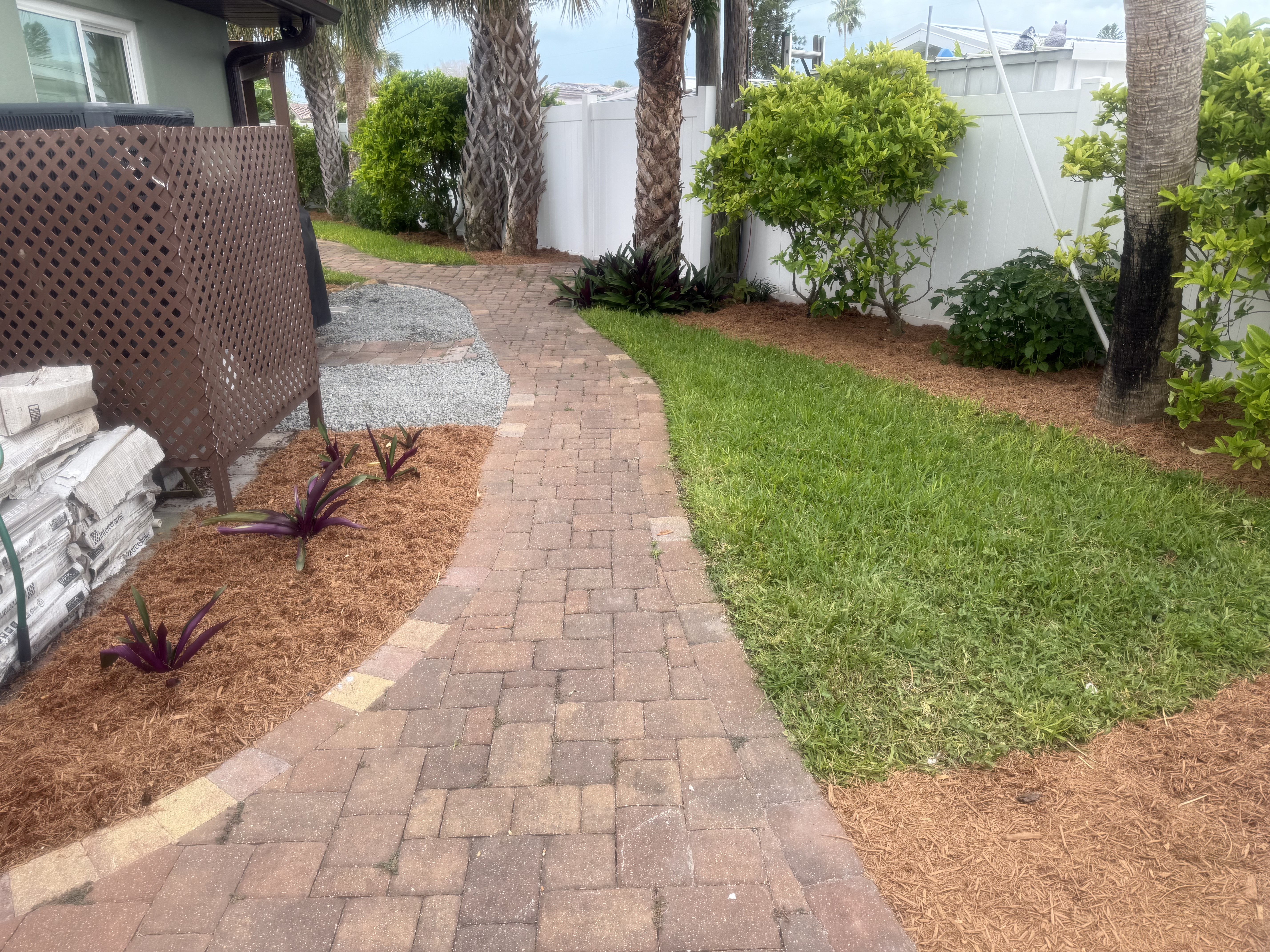 SPS project showing a paver walkway beside lawn and garden beds